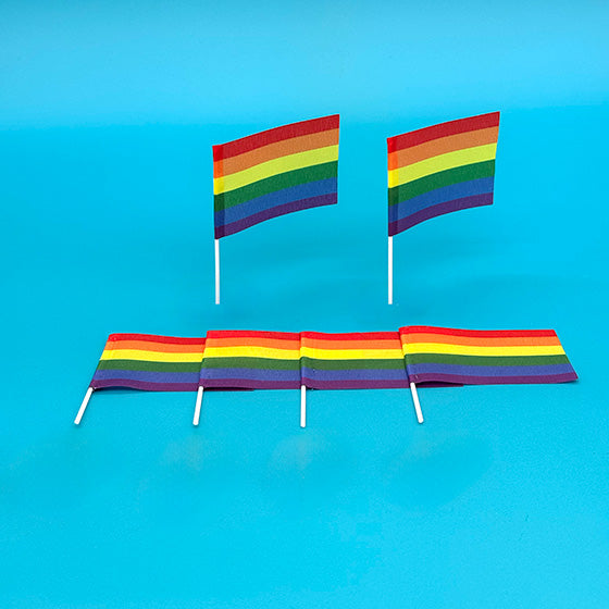 Six rainbow flags displayed on bright blue background.