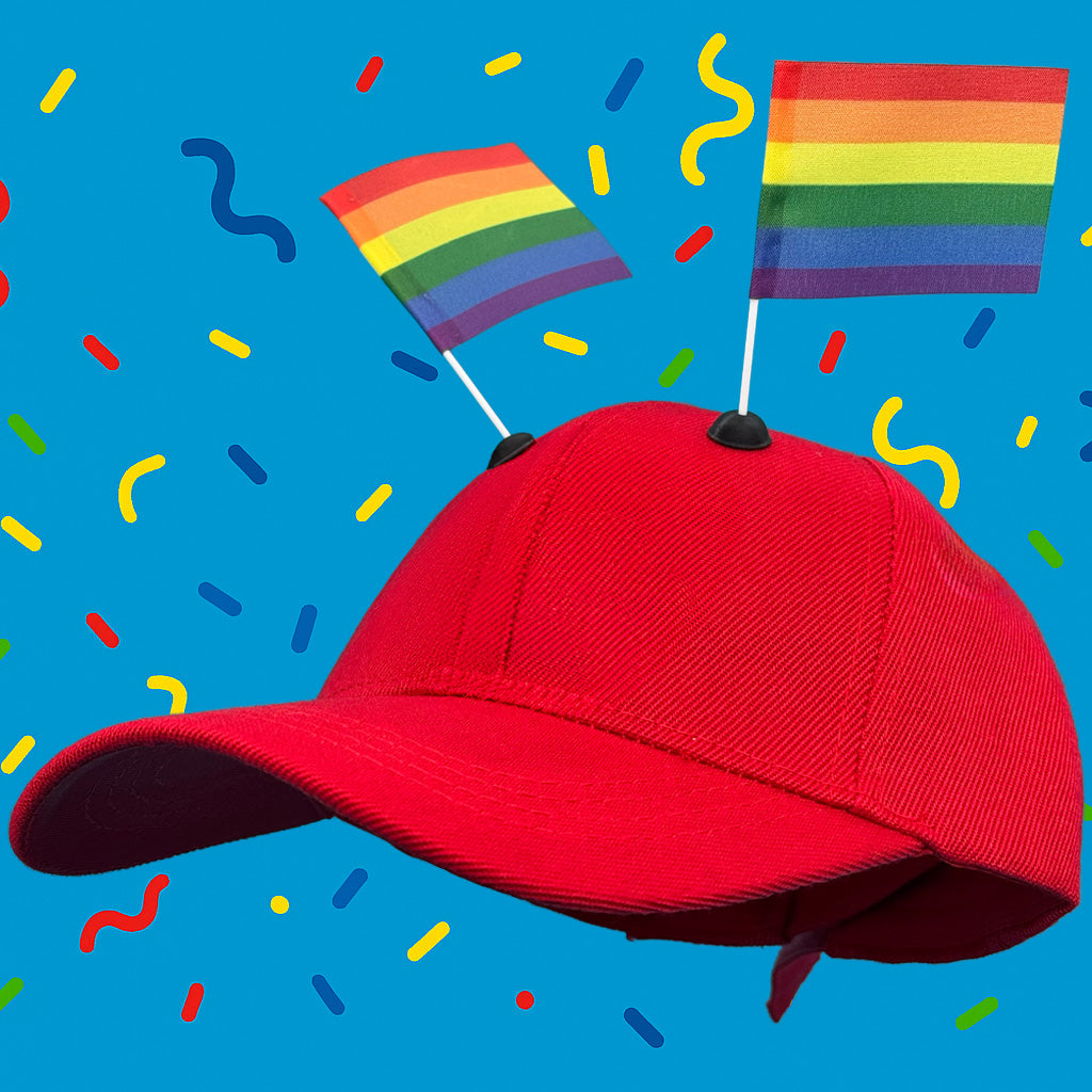 Red baseball cap featuring two rainbow CapFlags installed, showing the versatile mounting system against a blue background