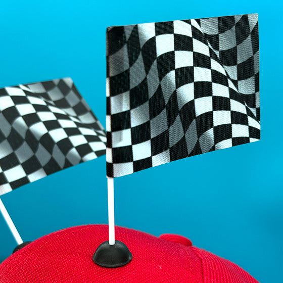 Red baseball cap featuring two Checkered Race flag CapFlags installed, shown from the side against blue background