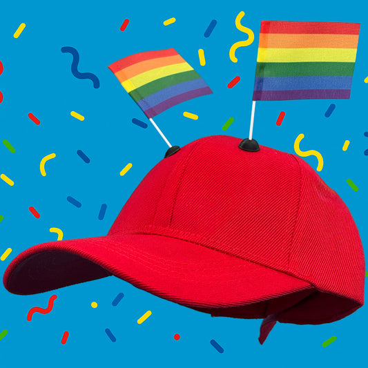 Red baseball cap featuring two rainbow CapFlags installed, showing the versatile mounting system against a blue background